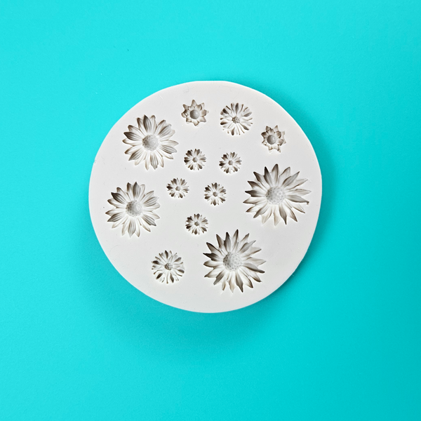 'Daisy Icon Silicone Mould for Floral Baking,' 'Assorted Daisy Shapes Mold,' 'Durable and Versatile Daisy Mould.'